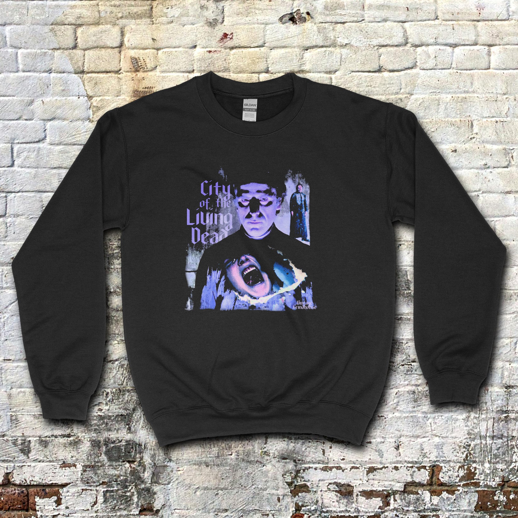 City of the Living Dead sweatshirt featuring eerie purple horror graphic with shadowy figure and screaming face on black fabric