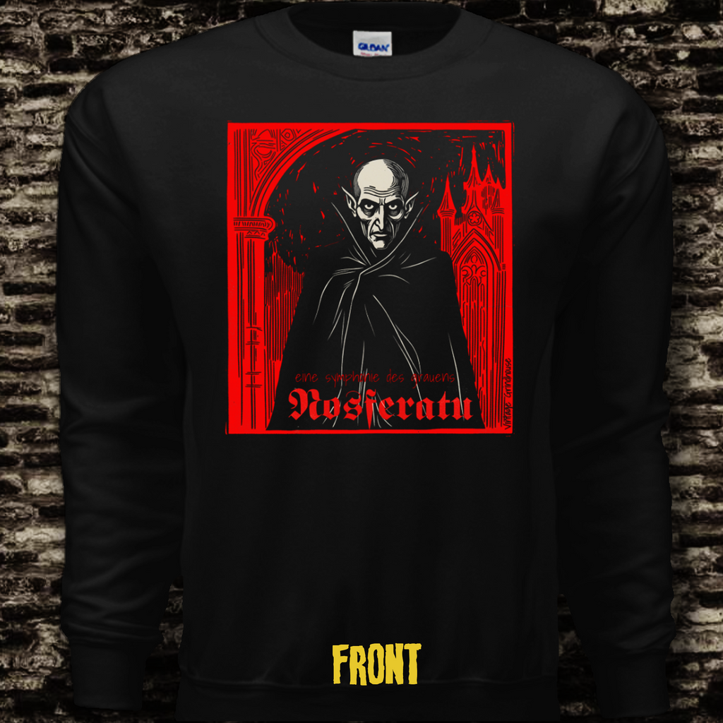 Black long-sleeve shirt with a graphic design of a hooded figure and text on a brick wall background.