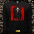 Black long-sleeve shirt with a graphic design of a hooded figure and text on a brick wall background.