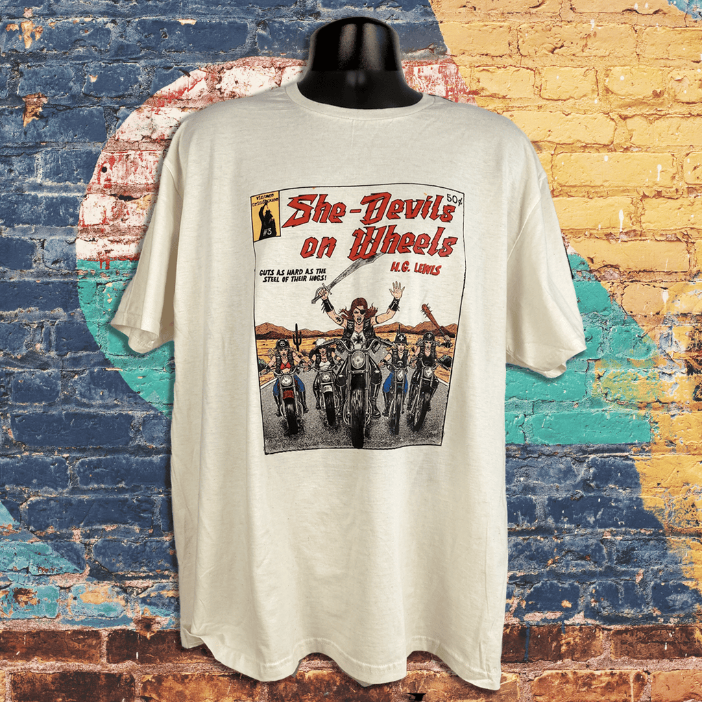 White t-shirt with graphic design of women on motorcycles against a colorful brick wall background