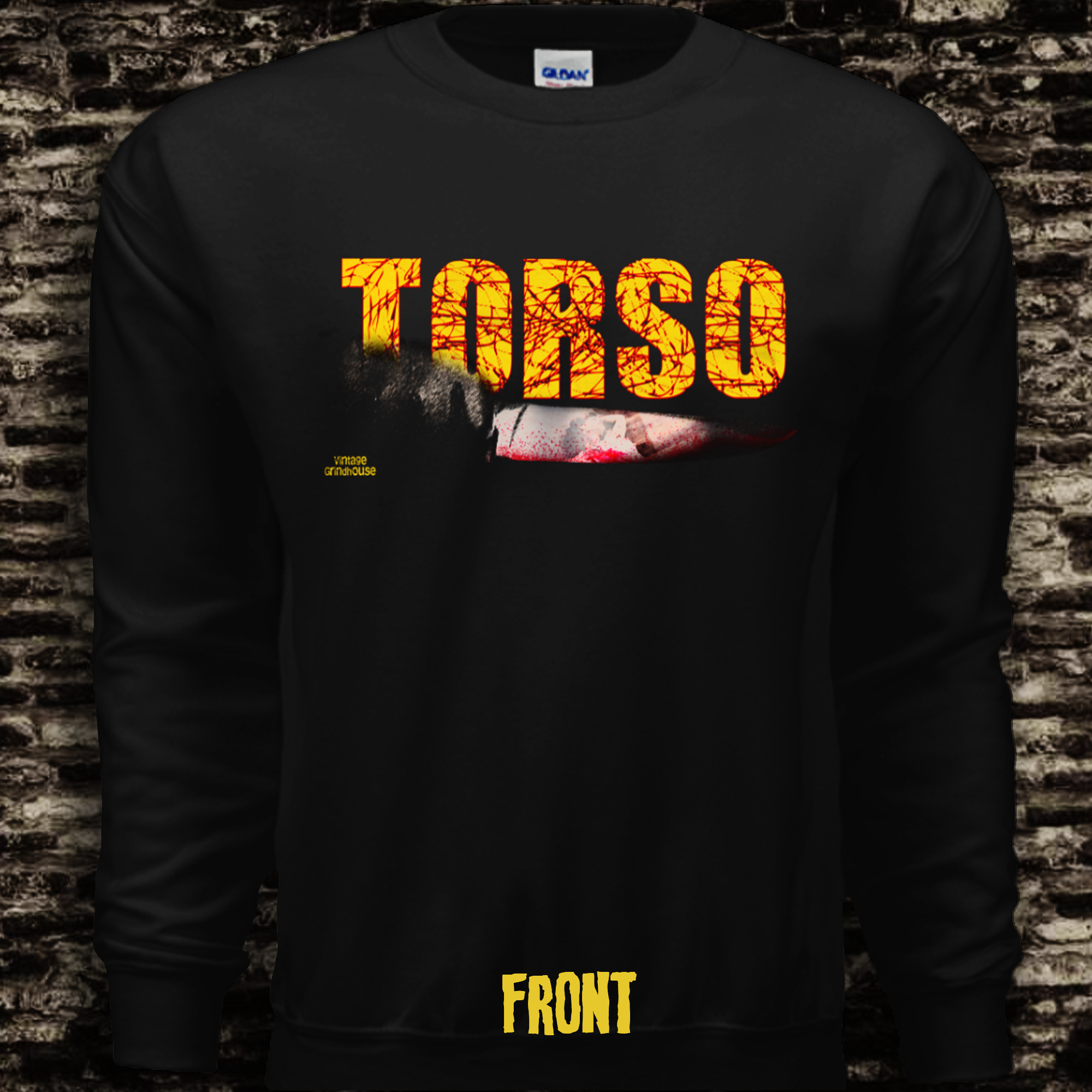 Black long-sleeve shirt with 'TORSO' printed in yellow on a brick wall background