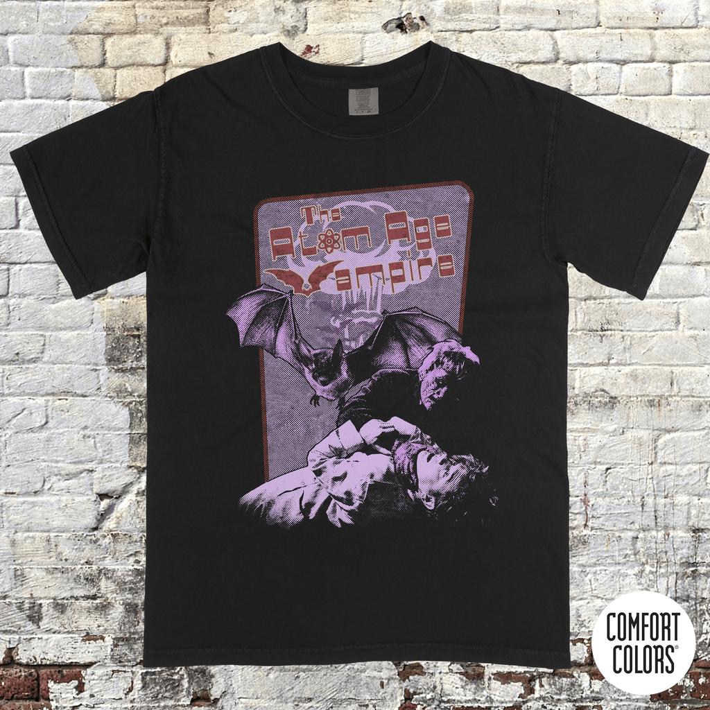 Atom Age Vampire t-shirt design featuring vintage horror art with bats and a distressed purple and red print on black.