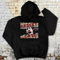 Black hoodie with graphic design on a textured brick wall background