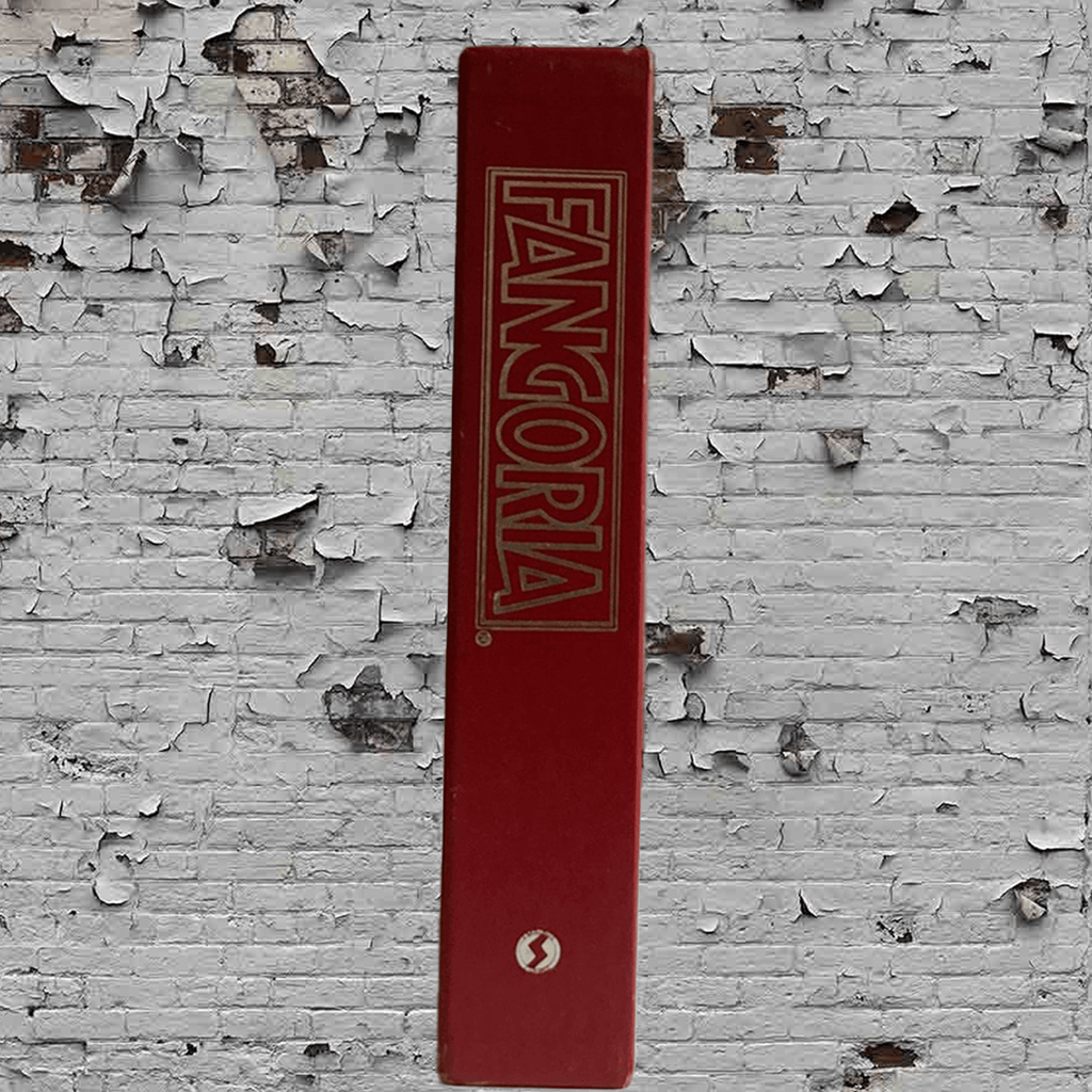 Red book with 'Fangoria' logo on a textured white wall