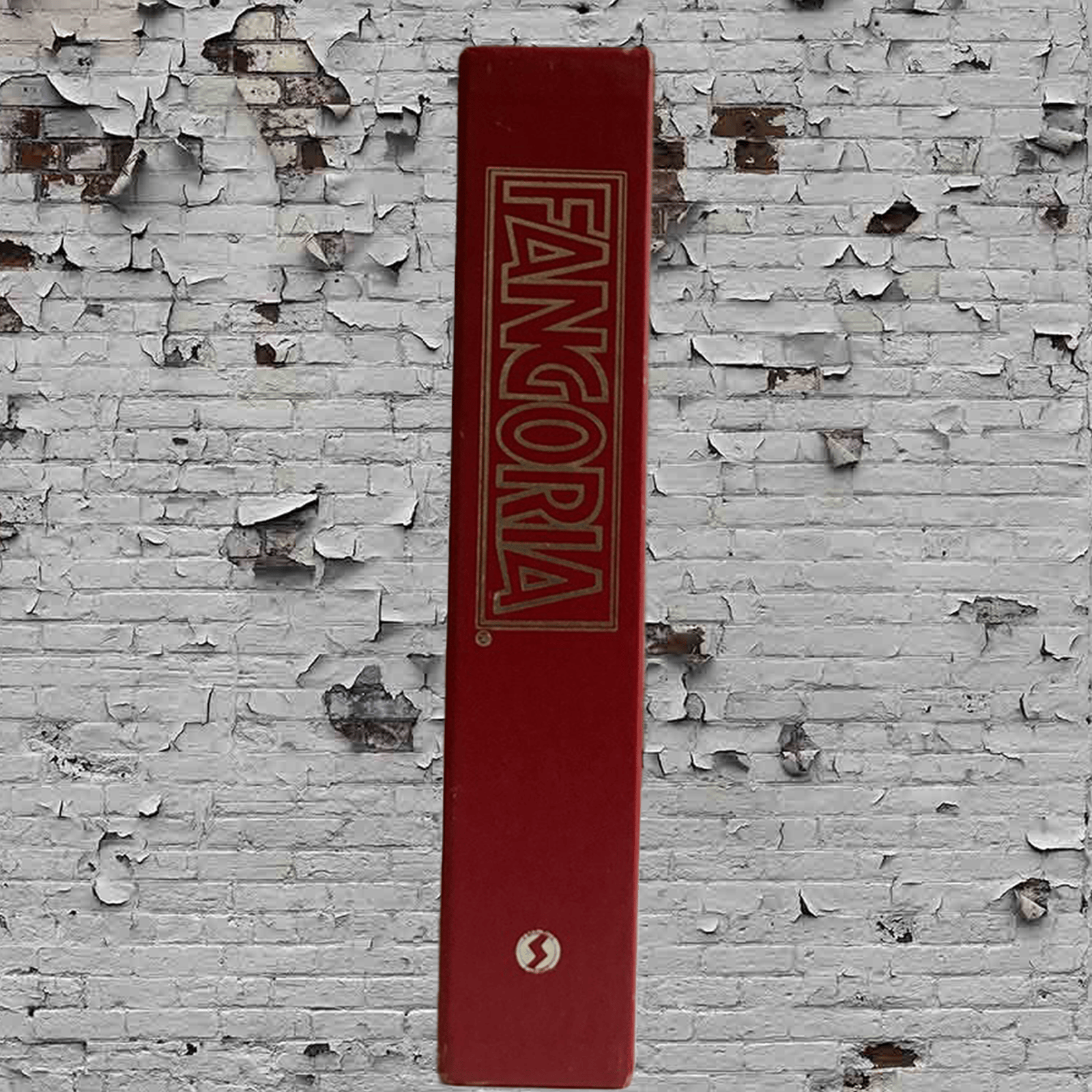 Red book with 'Fangoria' logo on a textured white wall
