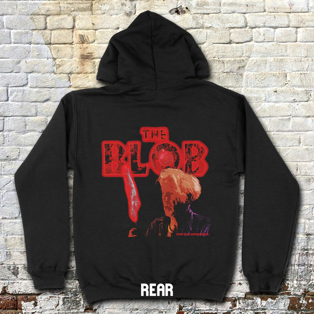 Black hoodie with 'The Blob' graphic design on a brick wall background