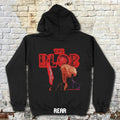 Black hoodie with 'The Blob' graphic design on a brick wall background