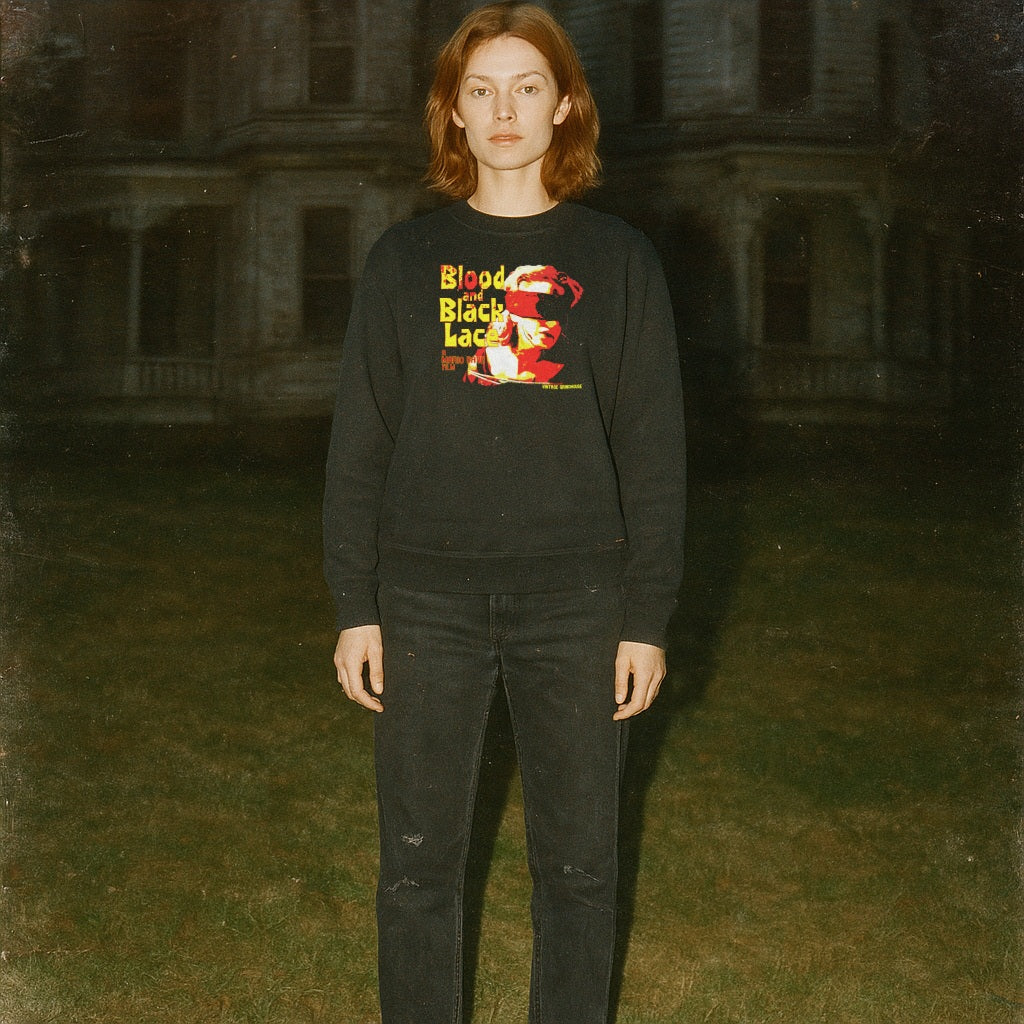 Blood and Black Lace sweatshirt with vivid red and yellow graphic worn by model standing outdoors in dim light