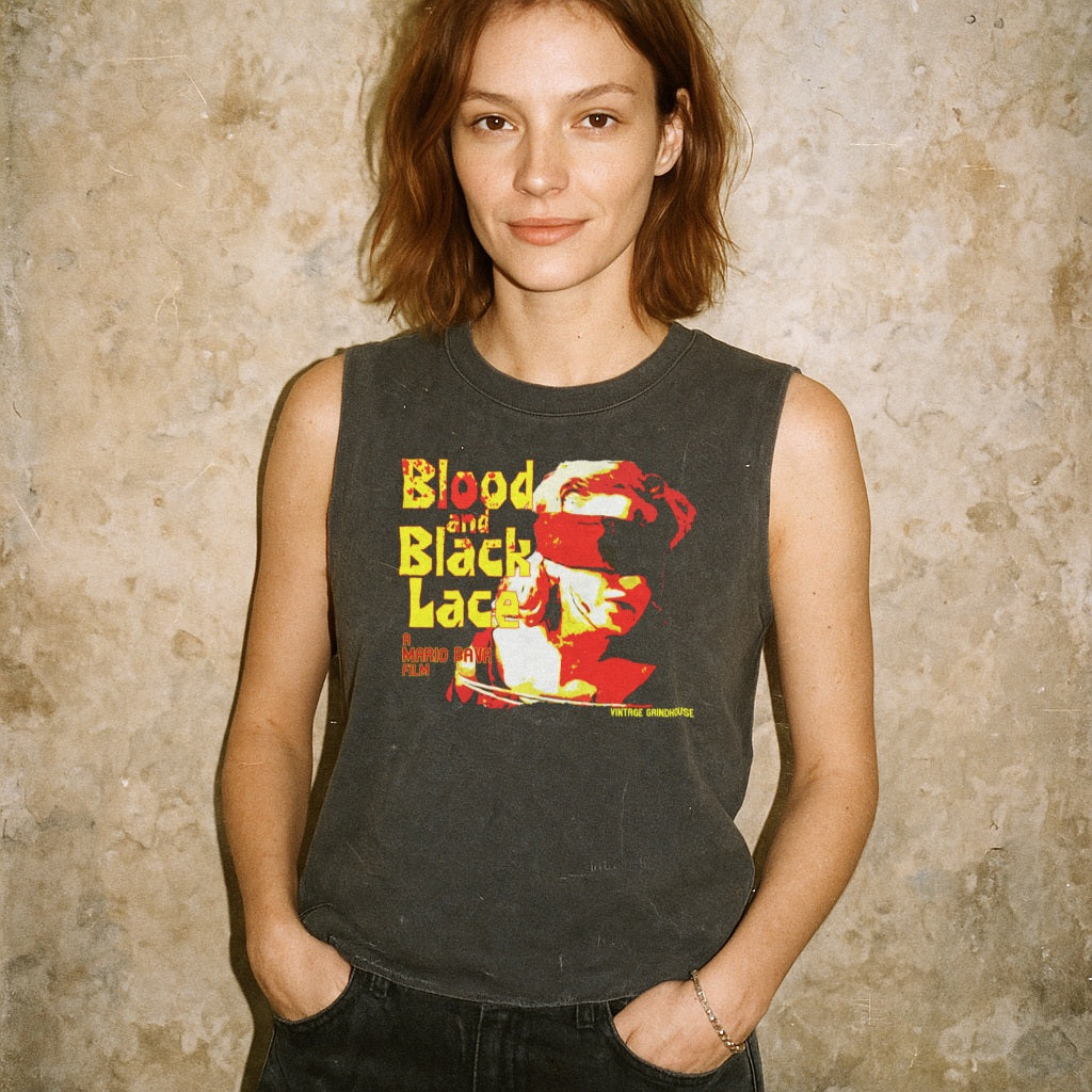 Woman wearing Blood and Black Lace muscle tank with graphic of masked face and bold yellow and red text on dark fabric