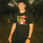 Person wearing a black t-shirt with graphic design outdoors