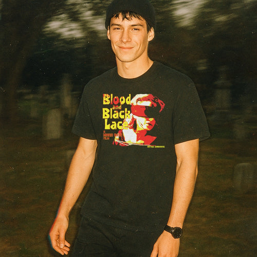 Person wearing a black t-shirt with graphic design outdoors