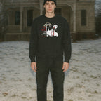 Man wearing Blood for Dracula sweatshirt with graphic of vampire biting neck and dripping blood on black fabric outdoors