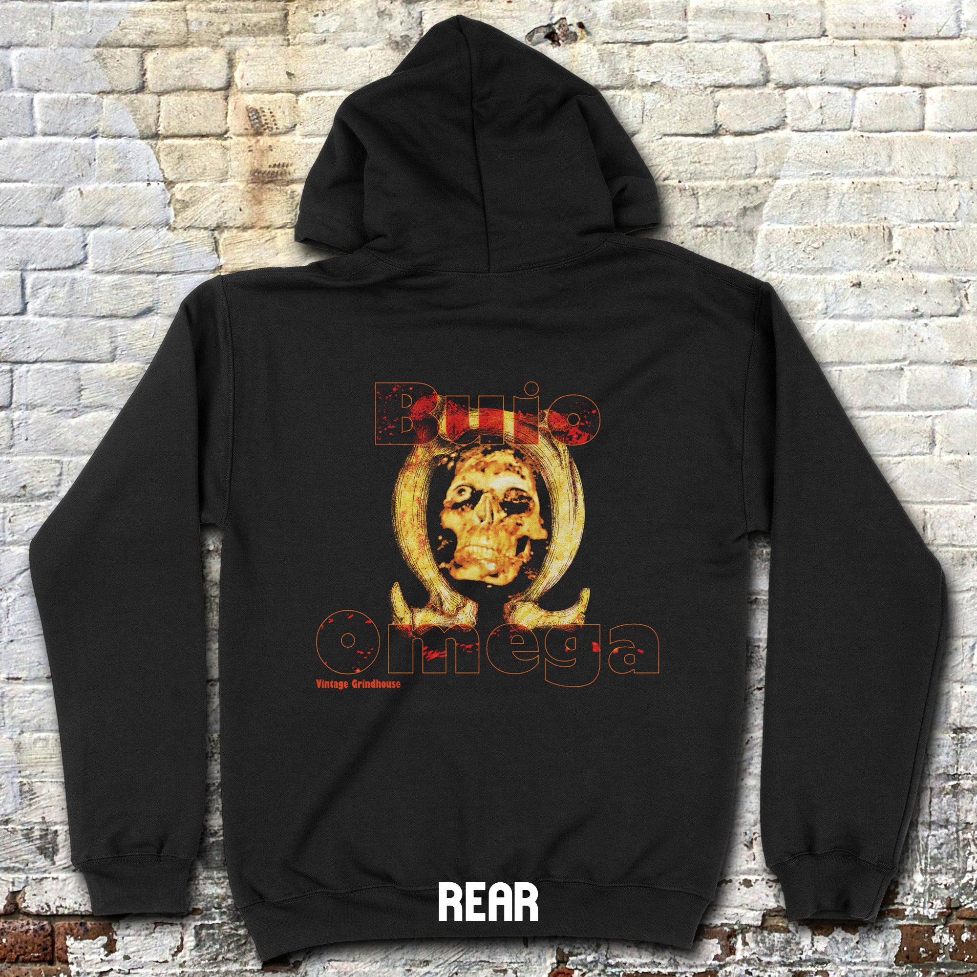 Black hoodie with a graphic design on the back against a brick wall.