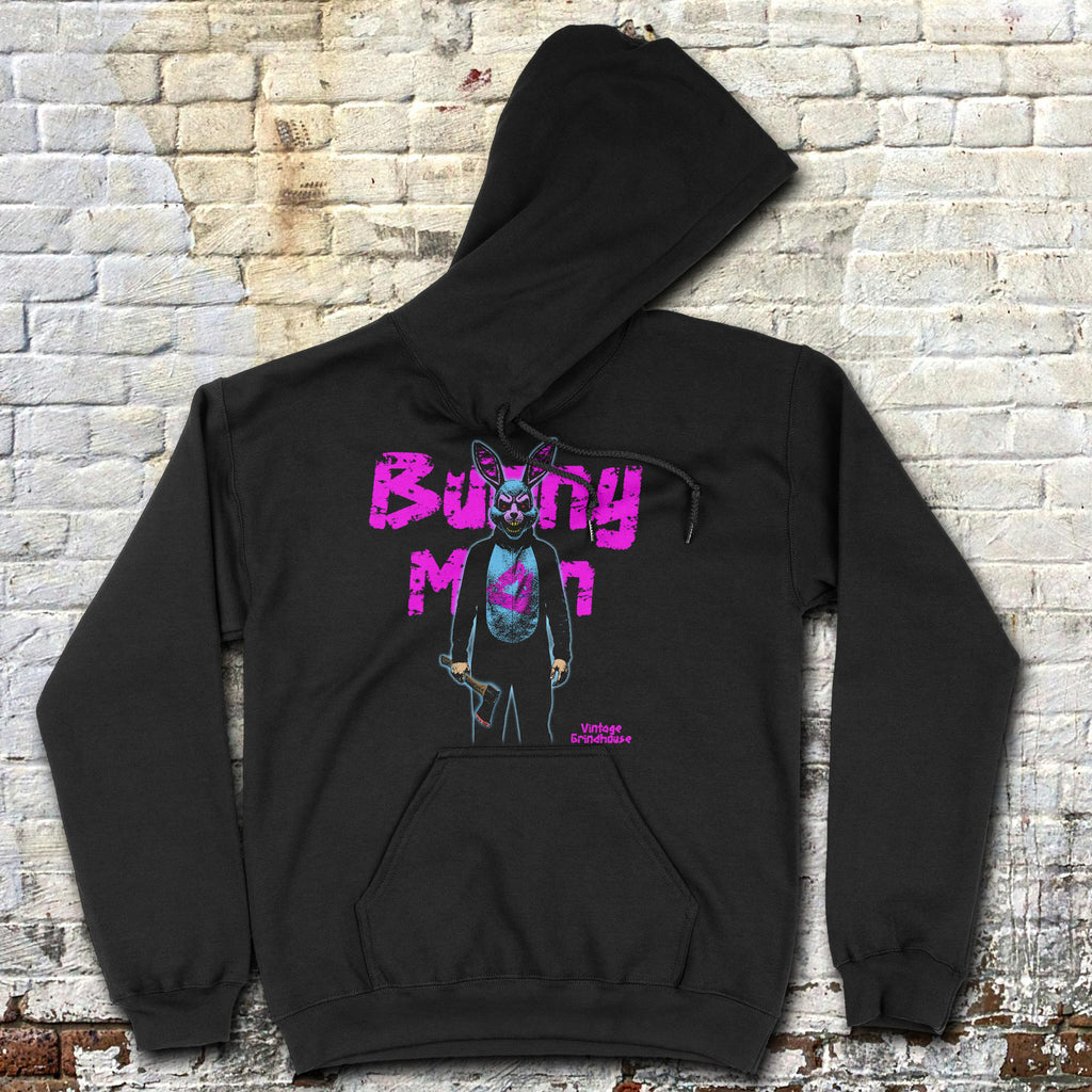 Black Bunnyman hoodie with neon purple graphic of masked character holding a weapon against brick wall background
