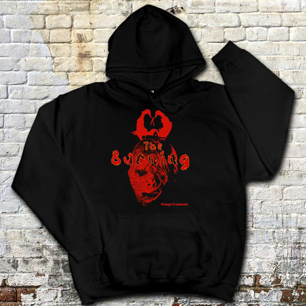 Black hoodie with red graphic design on a textured brick wall background