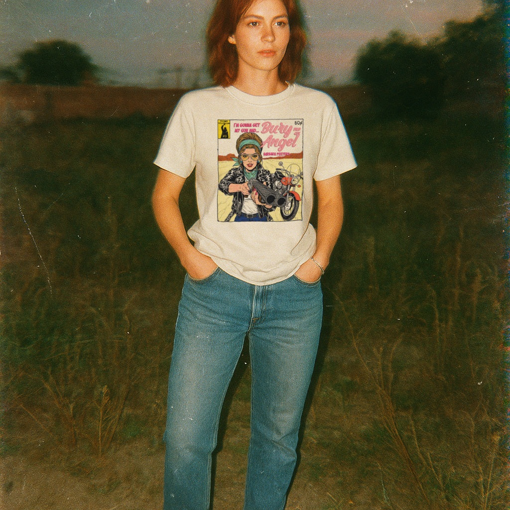 Person wearing a t-shirt with a graphic design in a field