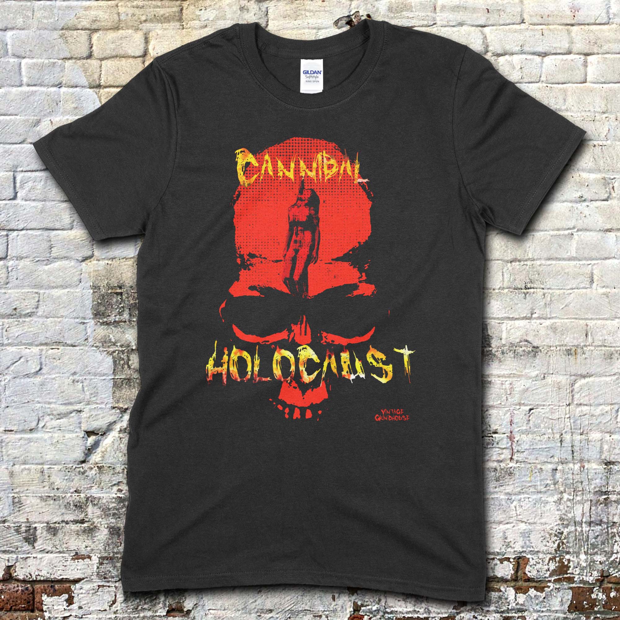 Black t-shirt featuring a red skull graphic with a naked figure inside and distressed yellow Cannibal Holocaust text on front