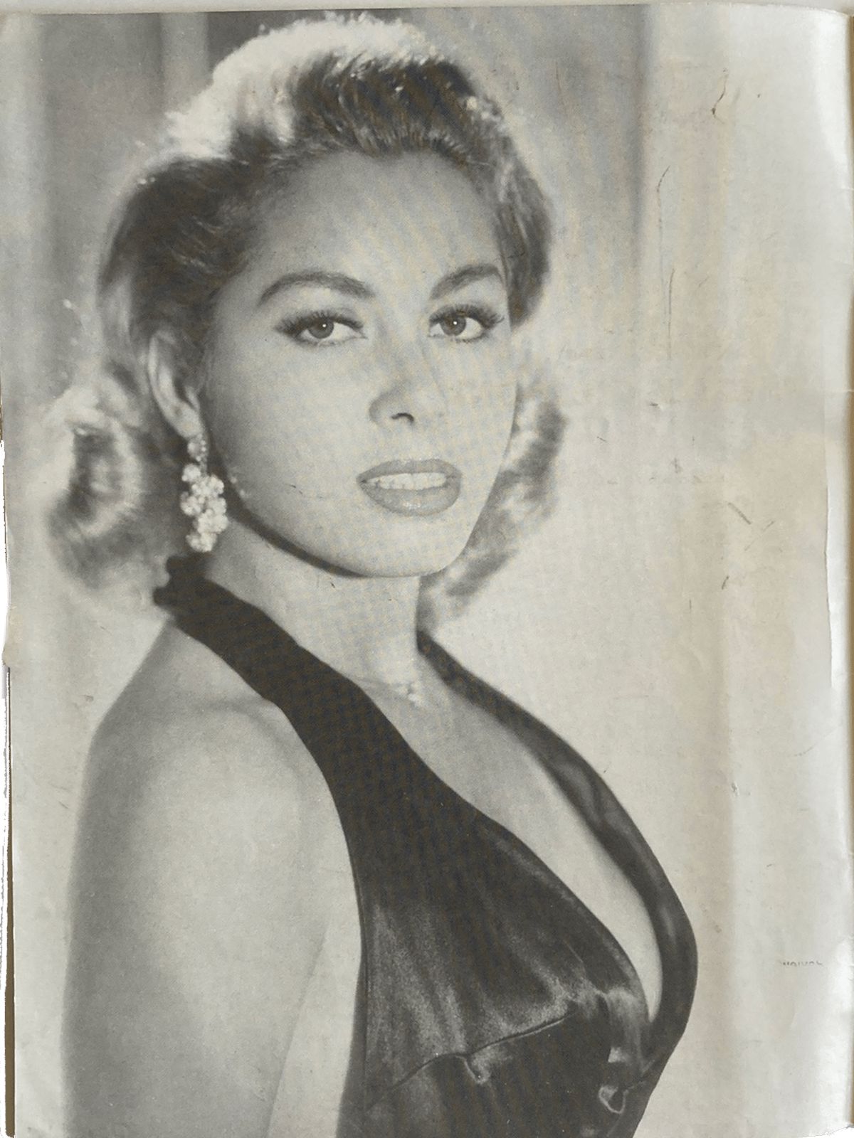 Vintage black and white photo of a woman in an elegant dress with decorative hairpiece.