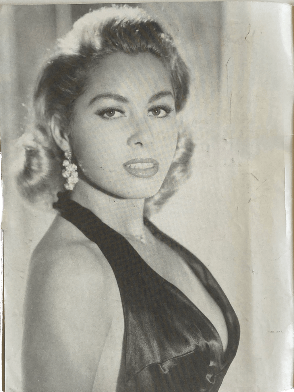 Black and white portrait of a woman in an elegant dress with decorative hairpiece.