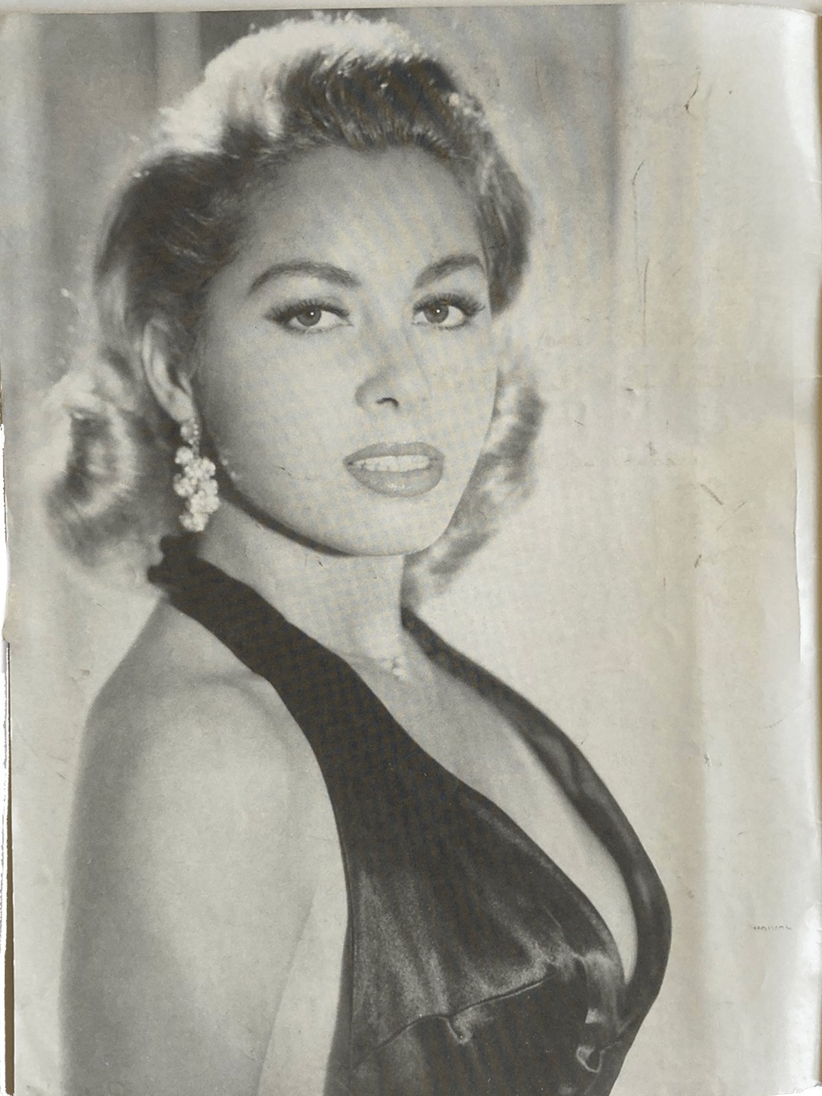 Black and white portrait of a woman in an elegant dress with decorative hairpiece.