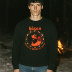 Man wearing black Häxan - Witchcraft Through the Ages sweatshirt with vintage occult red graphic at night near campfire