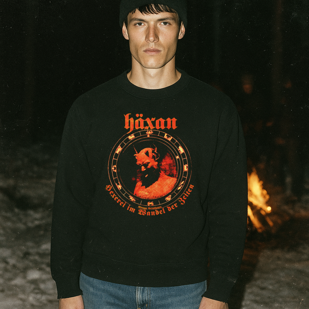 Man wearing black Häxan - Witchcraft Through the Ages sweatshirt with vintage occult red graphic at night near campfire