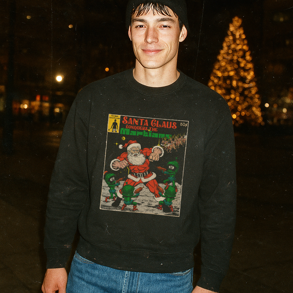 Man wearing Santa Clause Conquers the Martians sweatshirt with retro comic cover art near illuminated holiday tree at night