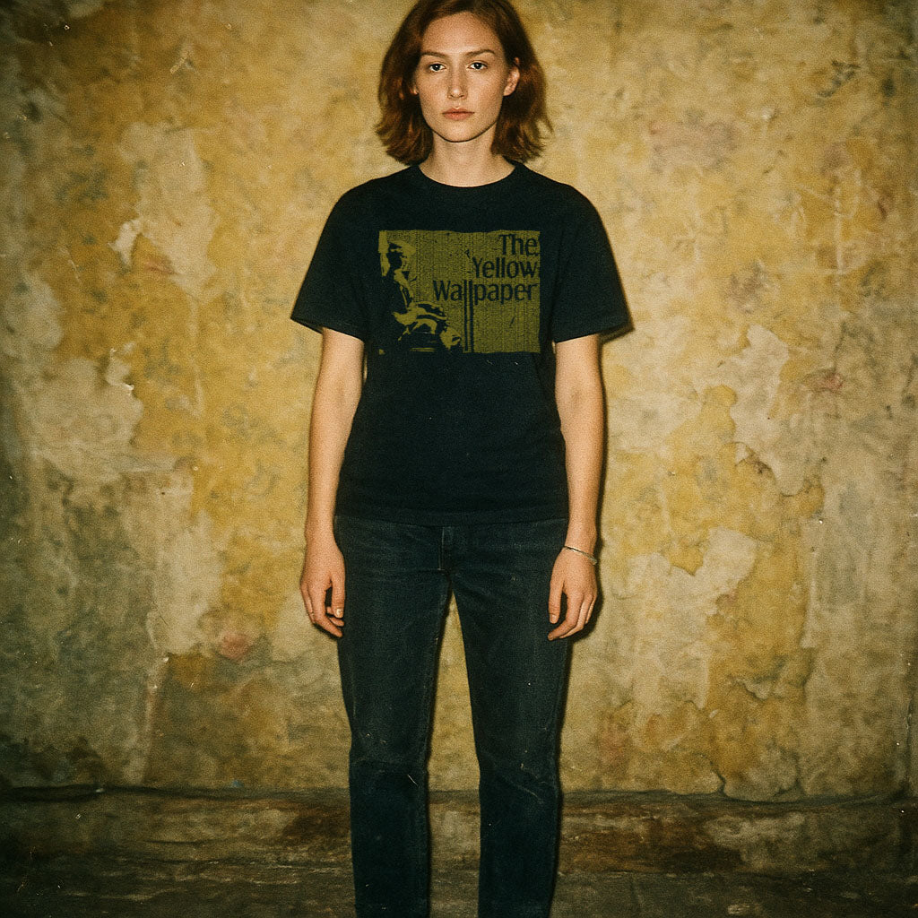 Person wearing black t-shirt with dark yellow block print and text reading The Yellow Wallpaper against textured background