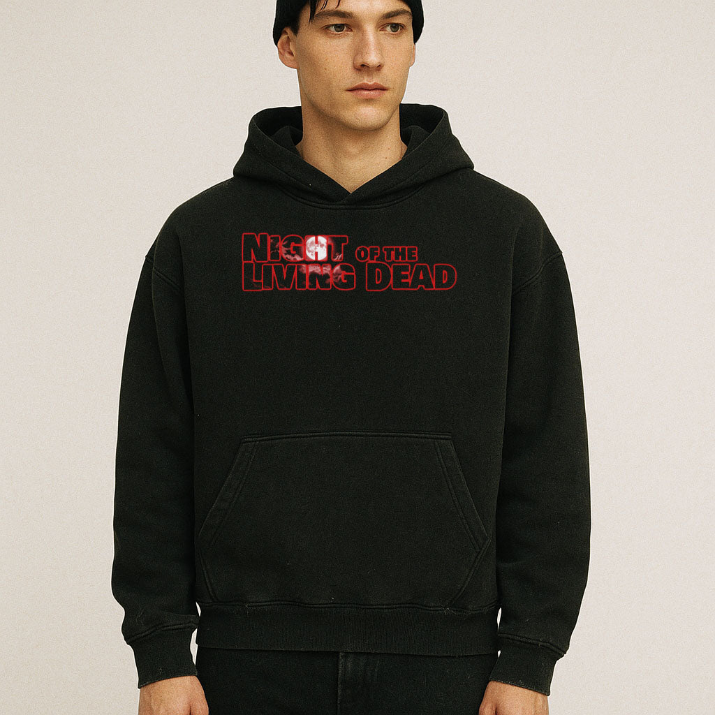 Person wearing a black hoodie with 'Night of the Living Dead' text on a plain background