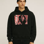 Model wearing Pieces hoodie - Torn Asunder Edition with torn vintage-style photo print on black fabric in studio setting