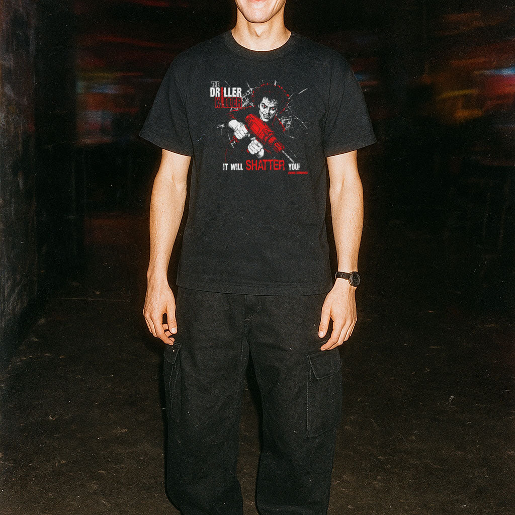 Person wearing a black t-shirt with graphic design in a dark alleyway
