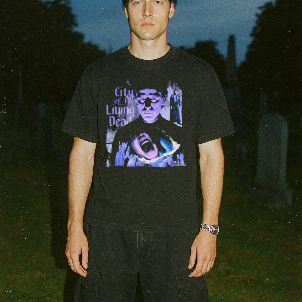 Person wearing a black t-shirt with graphic design in a cemetery
