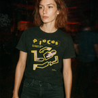 Person wearing a black t-shirt with yellow graphic design and text.