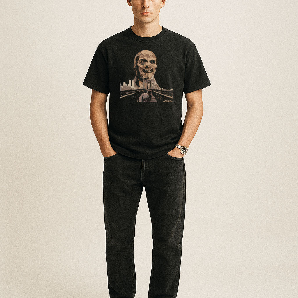 Black t-shirt featuring Zombi 2 graphic with a decayed zombie head looming over a city skyline and bridge scene
