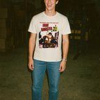 Man wearing white t-shirt with vintage Robot Monster graphic showing sci-fi robot and text in 3D style