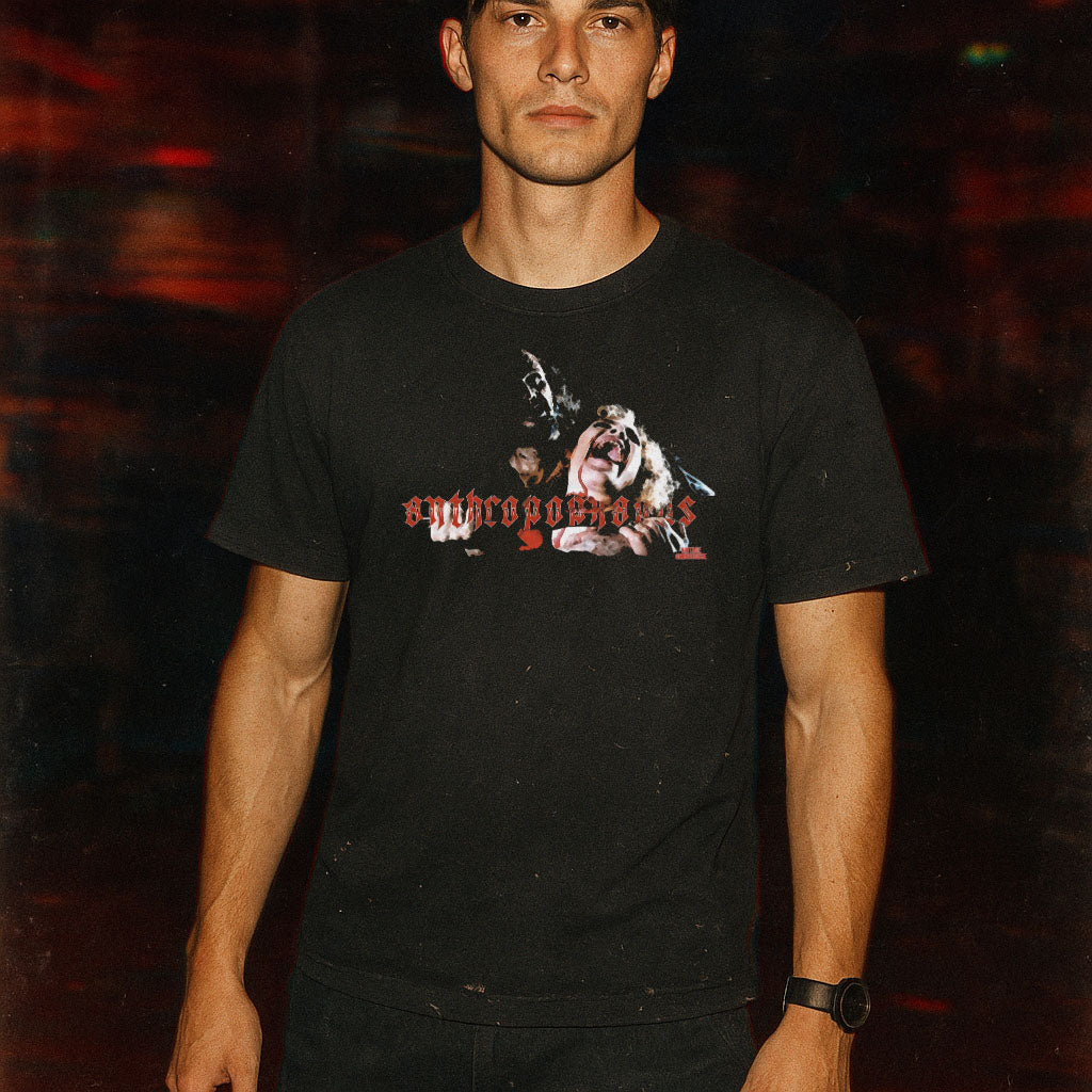 Person wearing a black t-shirt with graphic design and text against a dark background