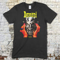 Black t-shirt featuring a graphic of hands holding a demonic silver mask with Demoni text in yellow on front
