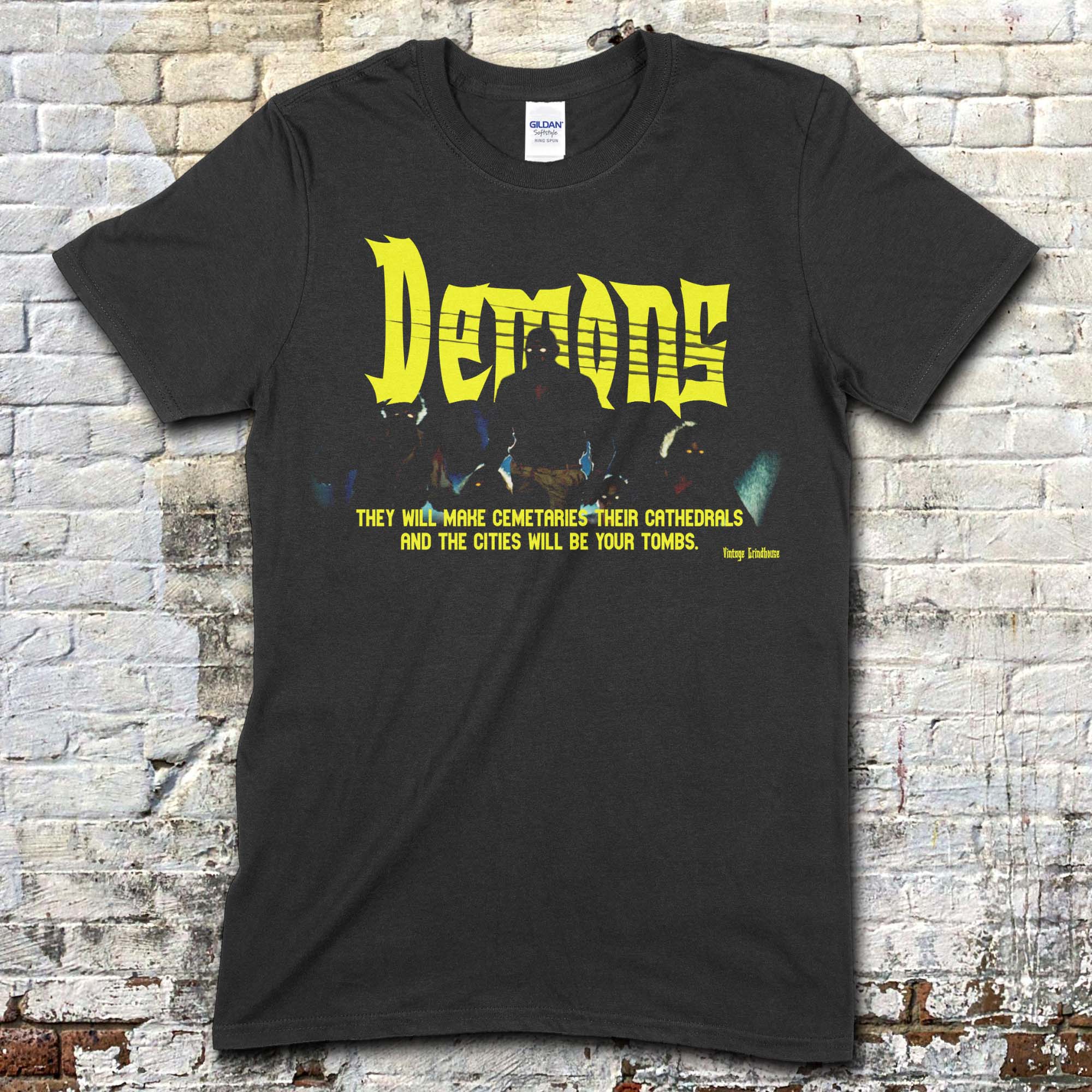 Black t-shirt featuring bold yellow Demons text and a dark graphic with a horror quote in yellow on front