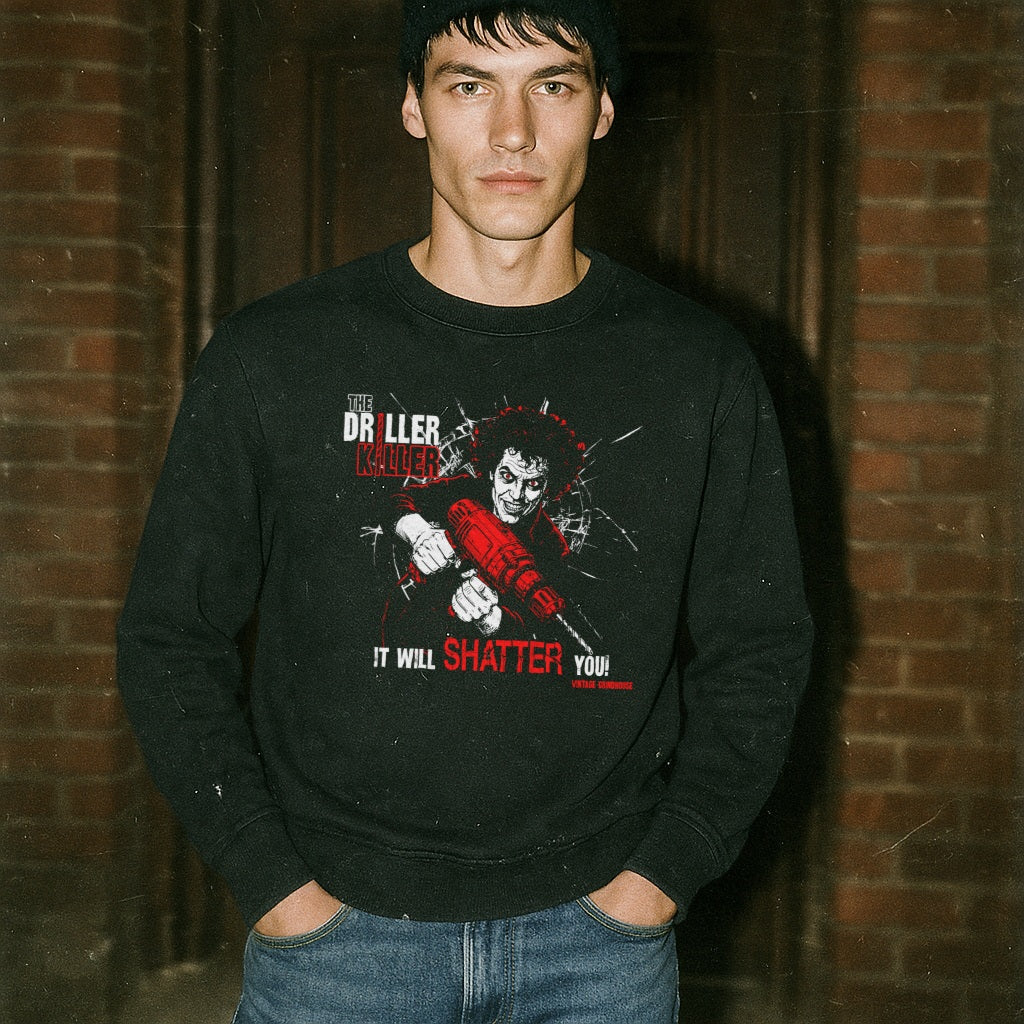 The Driller Killer sweatshirt with bold graphic of man wielding red drill breaking glass on black fabric