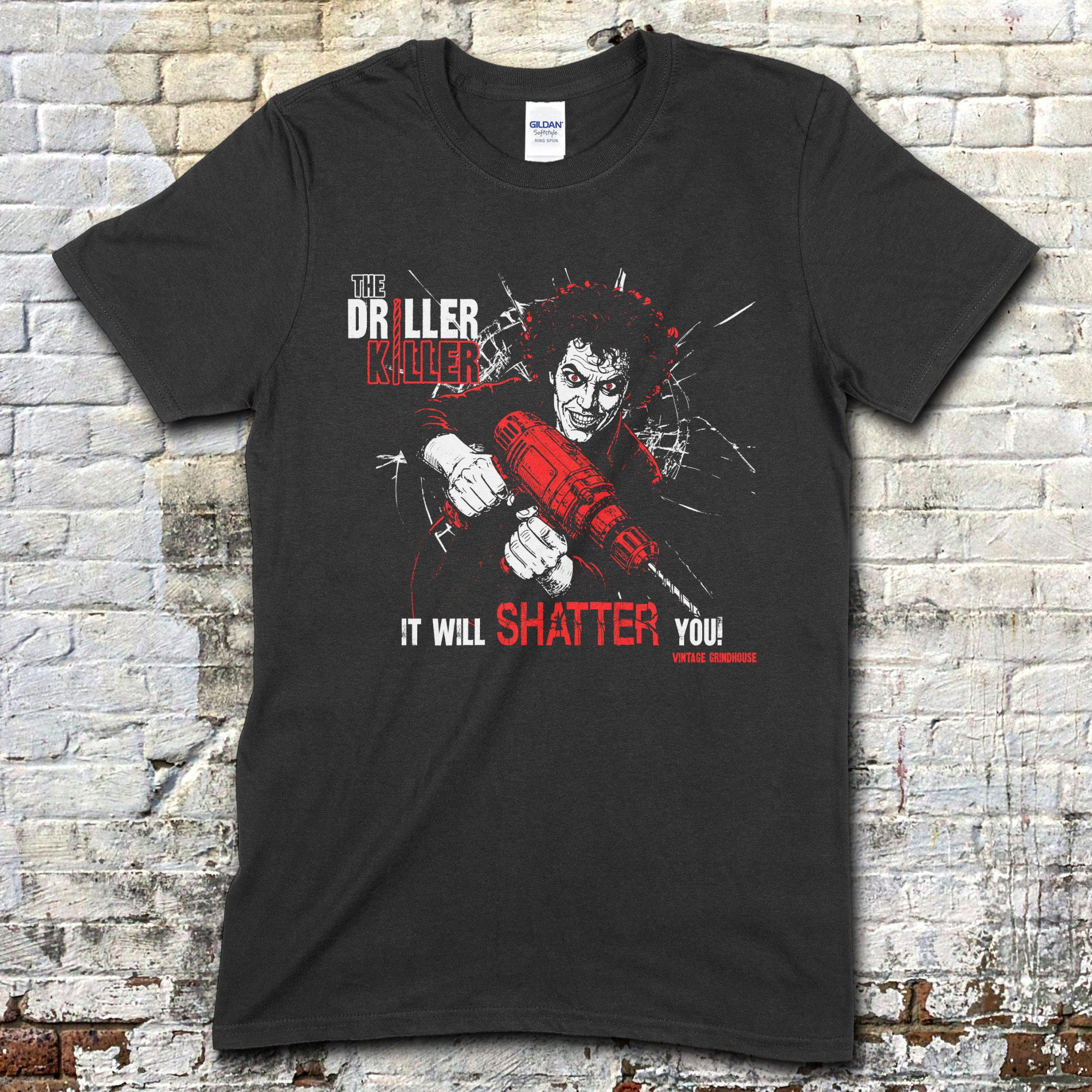 Black t-shirt featuring a graphic of a man with wild hair holding a red drill with The Driller Killer and shattered glass text on front