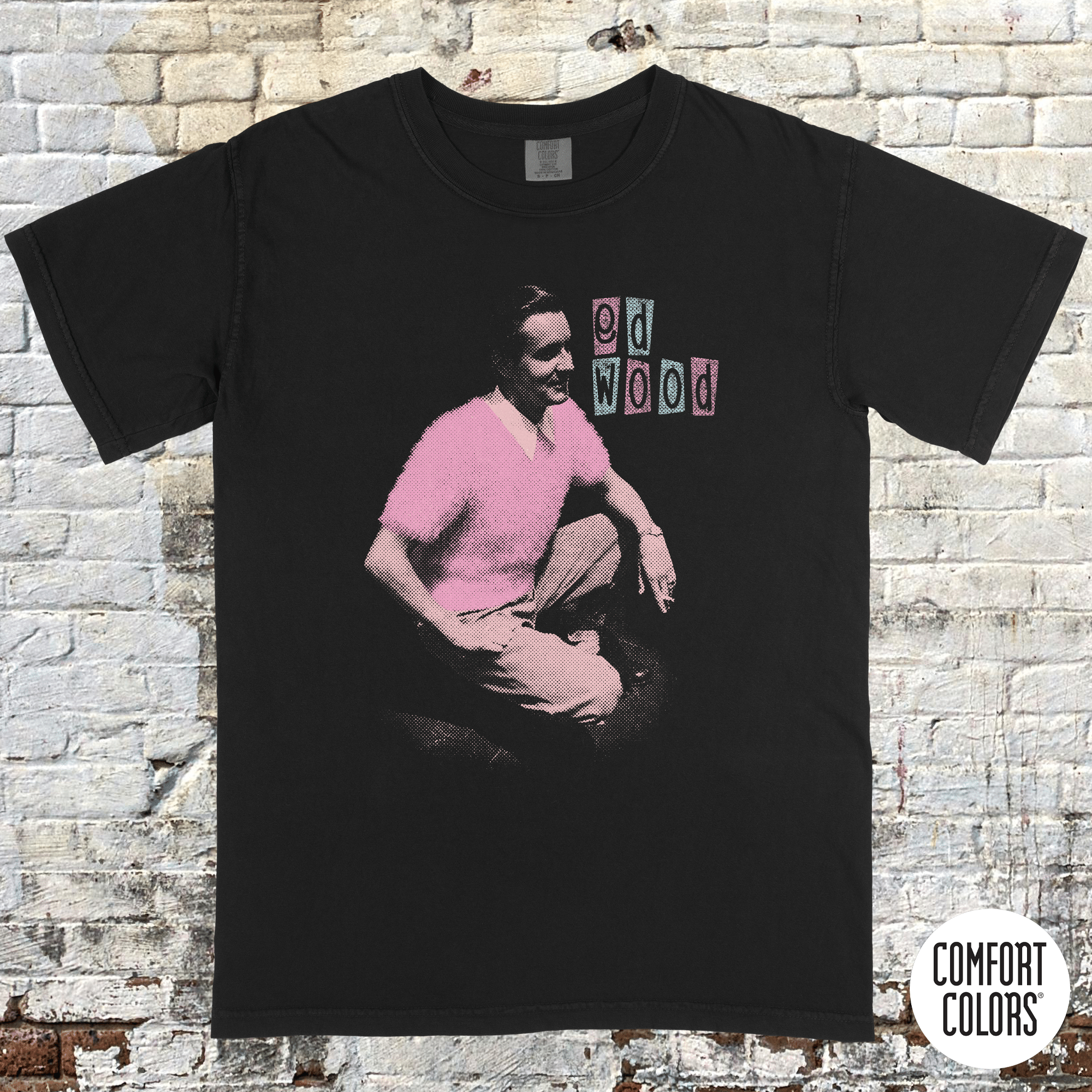 Ed Wood t-shirt featuring a vintage-style black tee with a pink graphic of Ed Wood and retro text blocks.