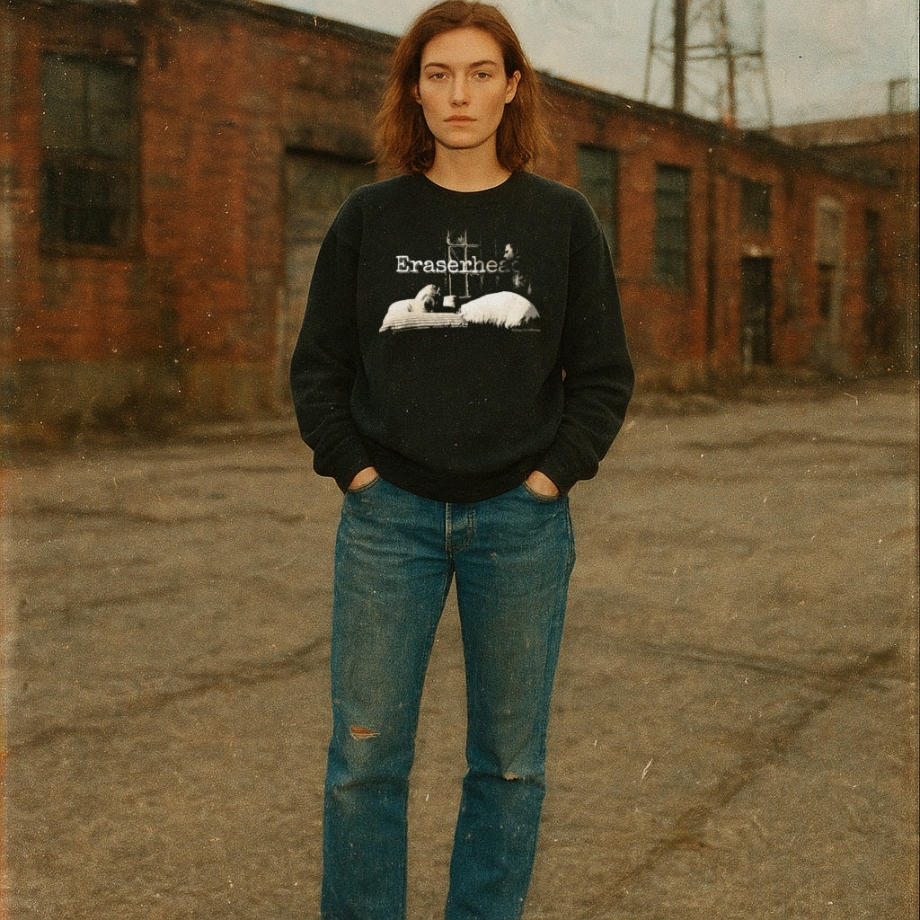 Eraserhead baby sweatshirt with monochrome baby graphic and vintage text worn by model against urban backdrop
