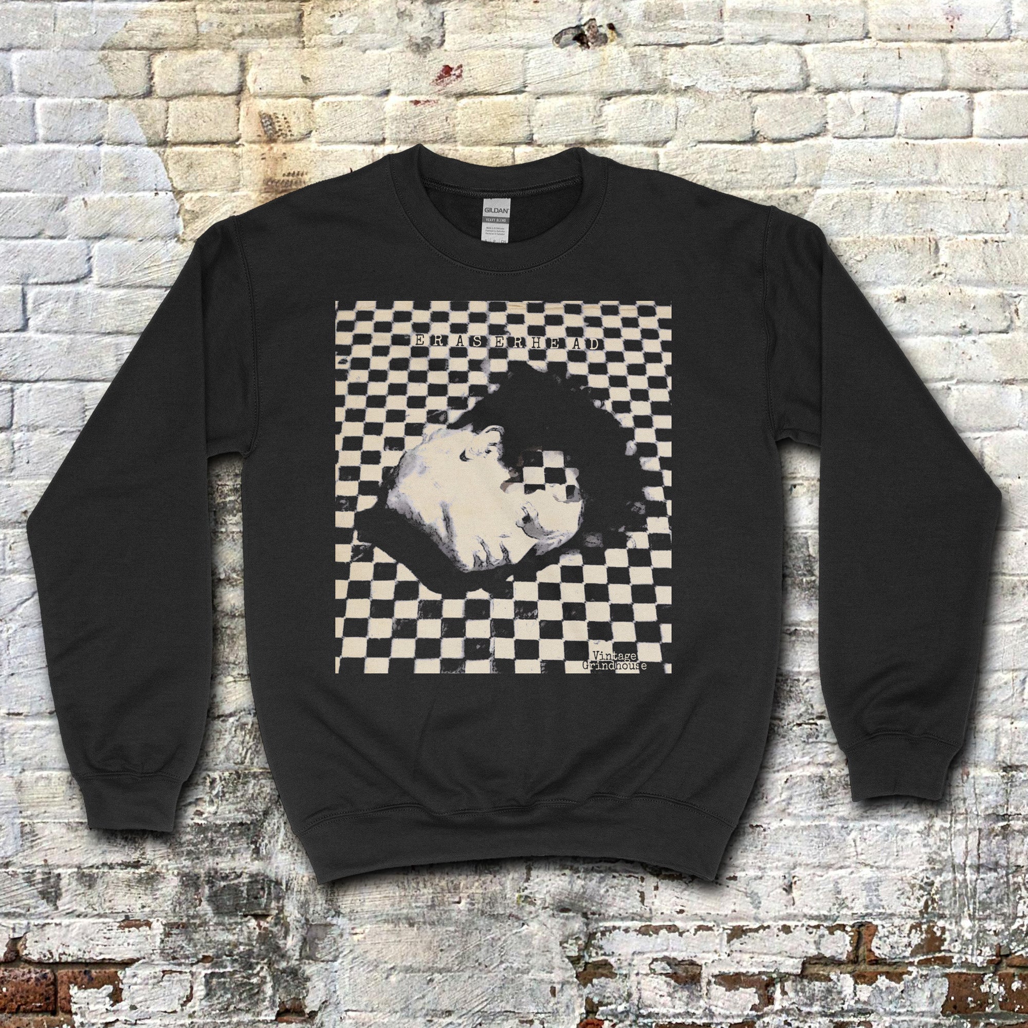 Black Eraserhead sweatshirt featuring surreal black and white checkerboard pattern with distorted head graphic centered on front