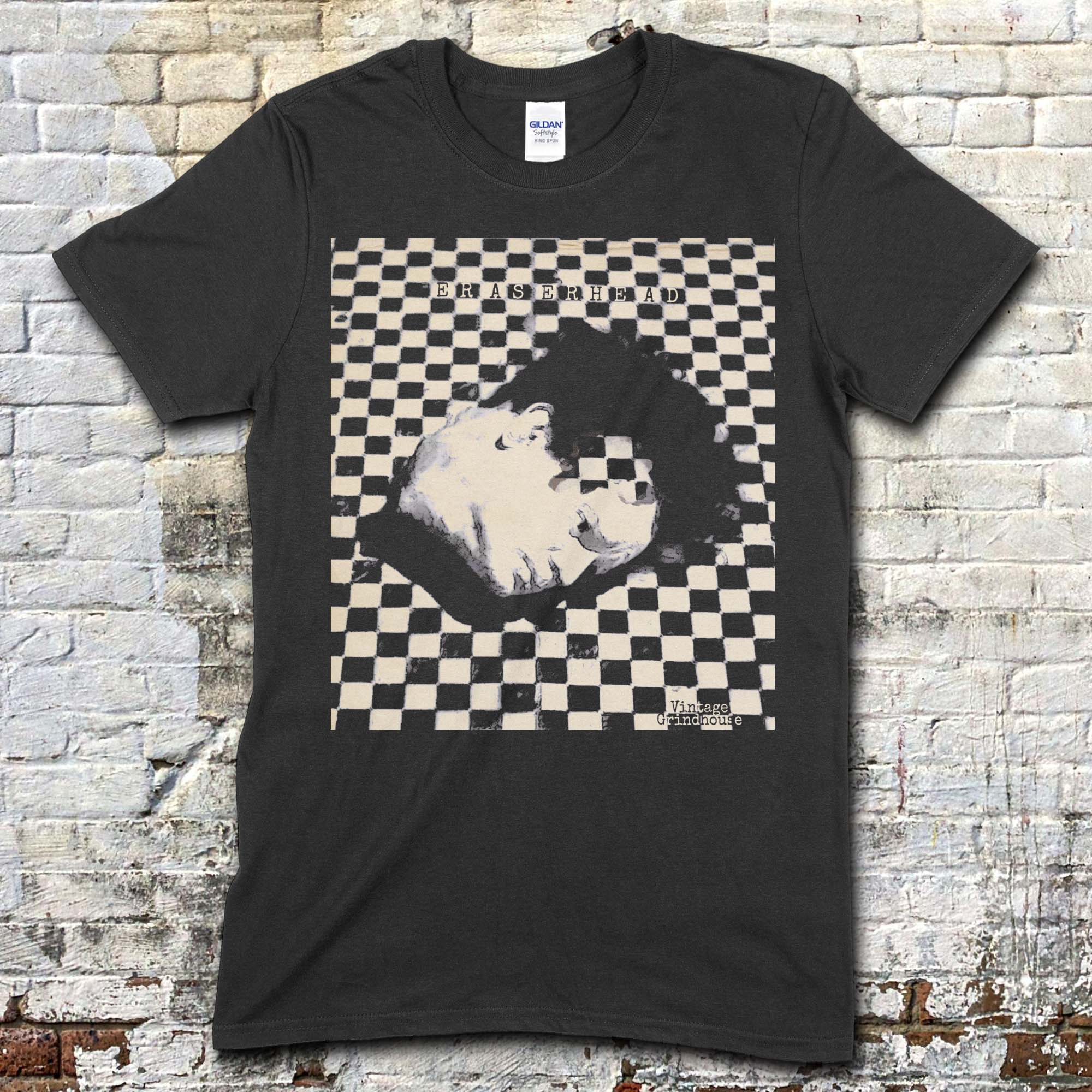 Black t-shirt featuring a surreal checkerboard graphic of a man's face with Eraserhead text on front