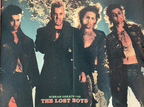 Four men in dark clothing with a snowy background, labeled 'The Lost Boys'.