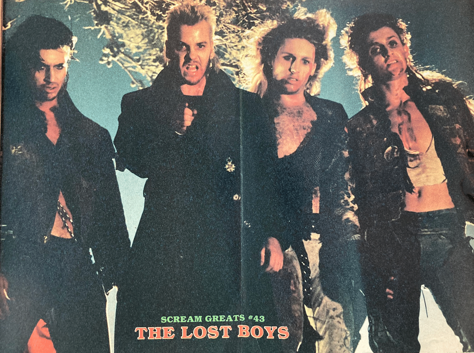 Four men in dark clothing with a snowy background, labeled 'The Lost Boys'.