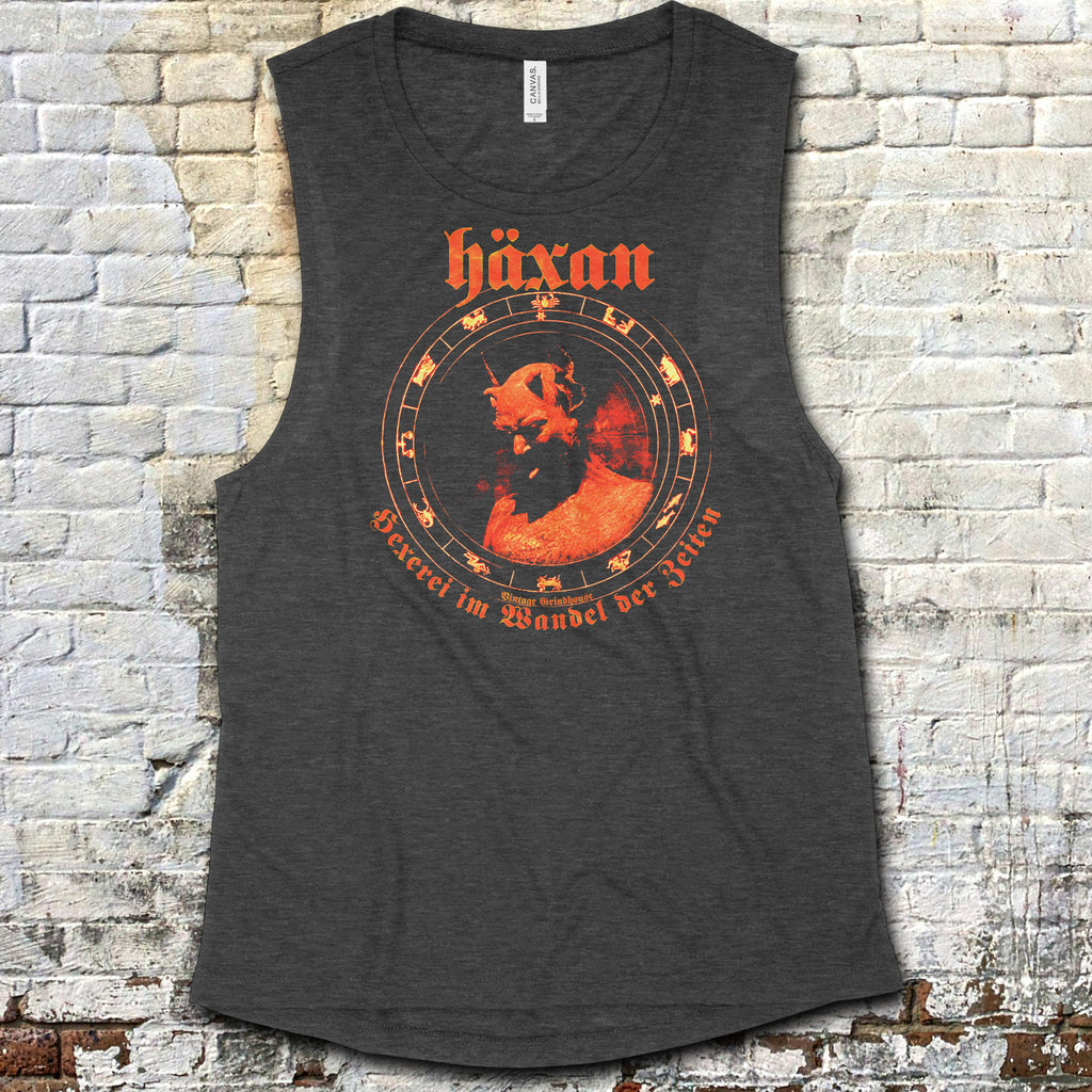 Häxan - Witchcraft Through the Ages muscle tank with vintage red occult-themed artwork on dark fabric against brick wall background
