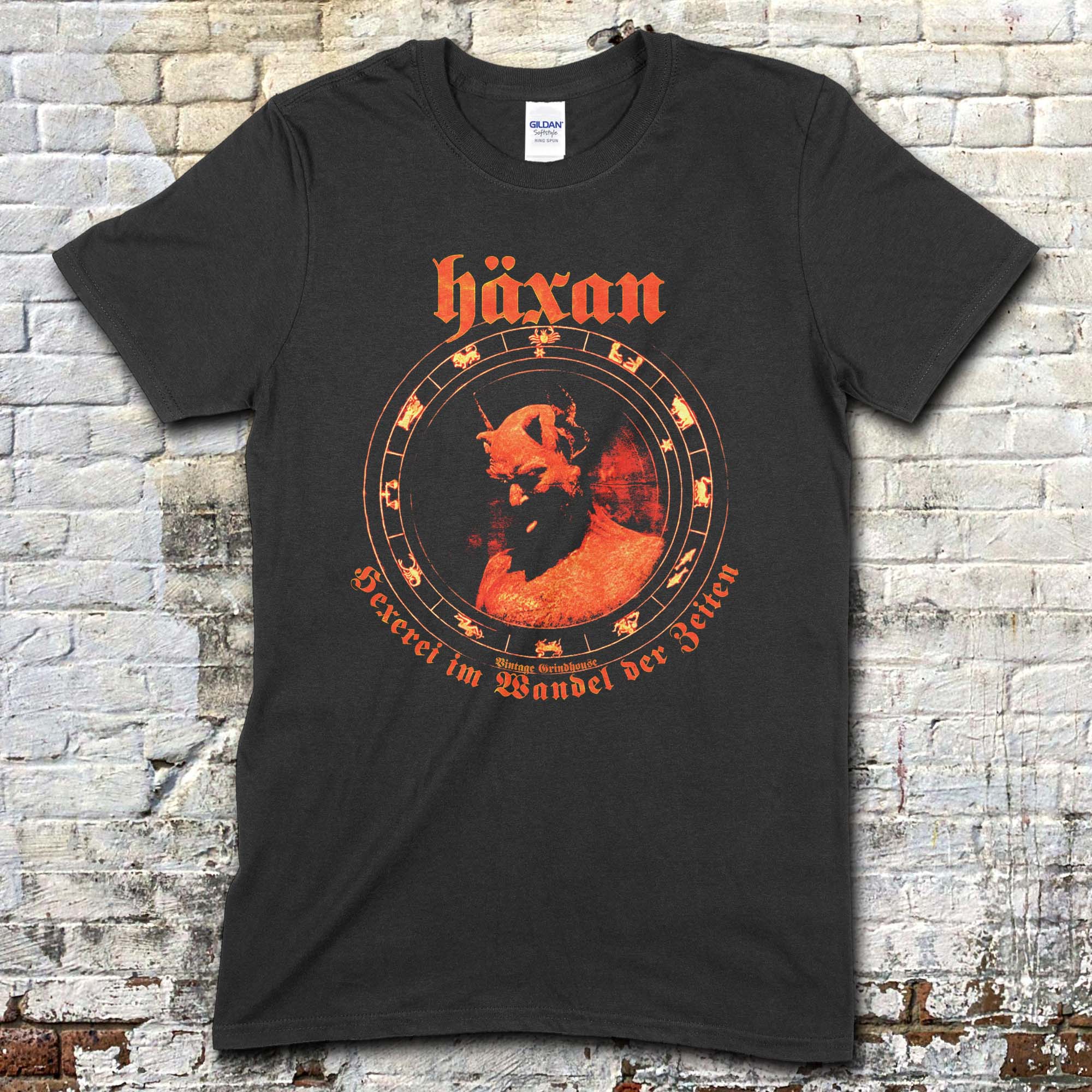 Black t-shirt featuring a red vintage graphic of a horned figure with Häxan text and circular occult symbols on front
