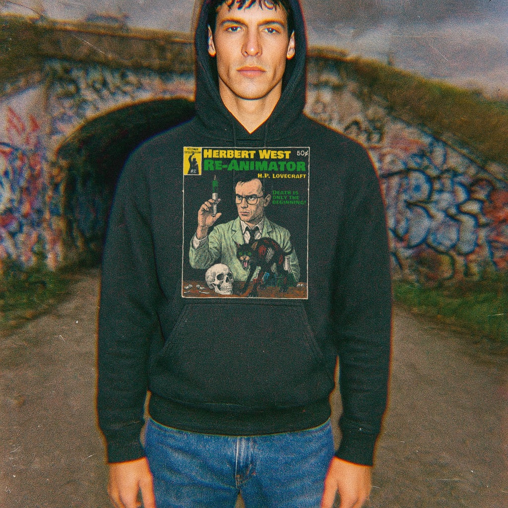 Model wearing Herbert West, Reanimator hoodie featuring vintage style horror illustration on front in outdoor urban setting