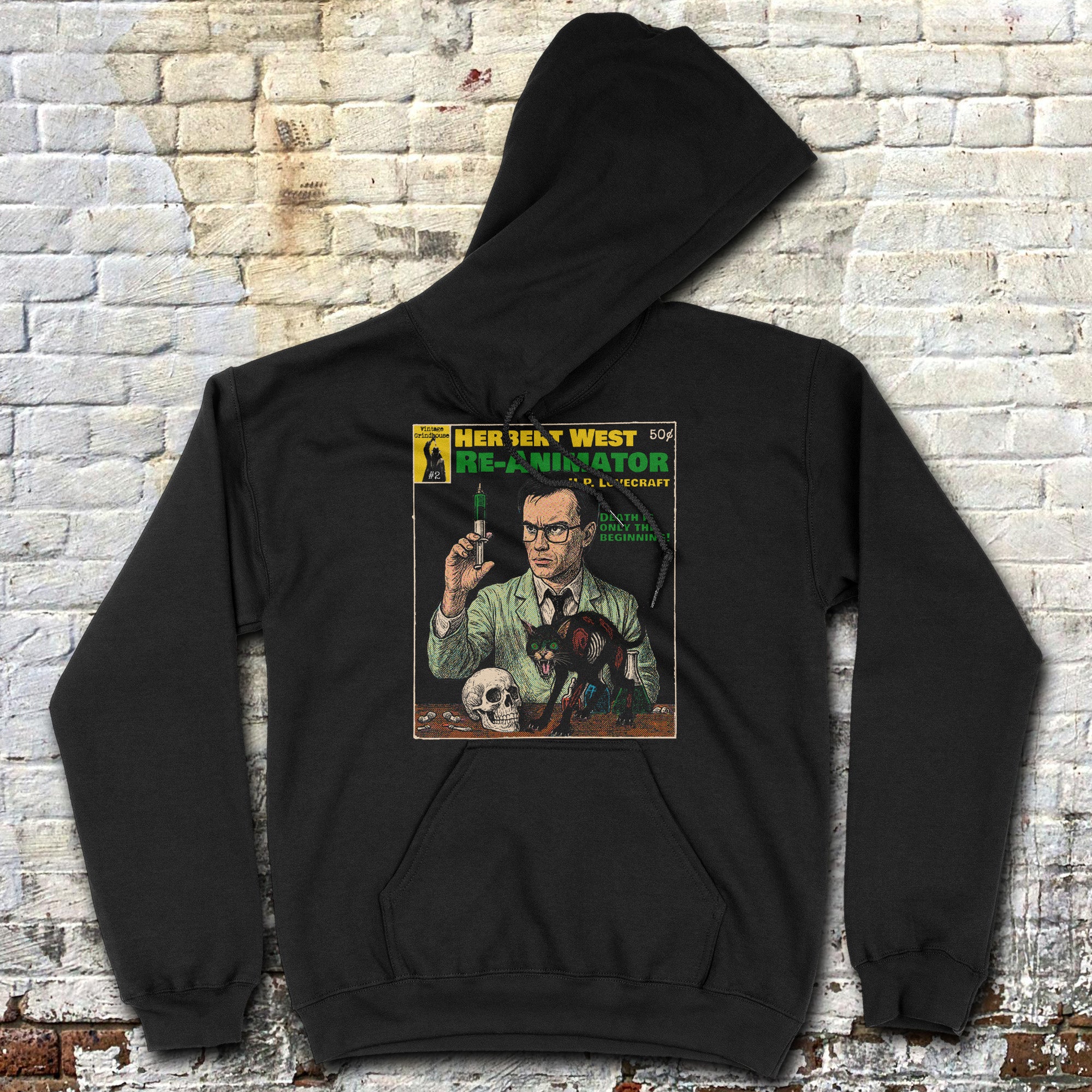 Black Herbert West, Reanimator hoodie with colorful vintage comic cover print on back against white brick wall